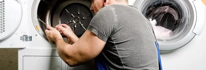 Dryer repair technician fixing a clothes dryer drum in Chula Vista, CA