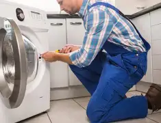 Washing machine repair technician servicing a front-load washer in Chula Vista, CA