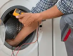 Washing machine repair technician testing a front-load washer with diagnostic tools in Chula Vista, CA