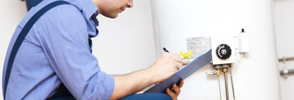 Water heater repair technician inspecting the unit and recording service notes in Chula Vista, CA